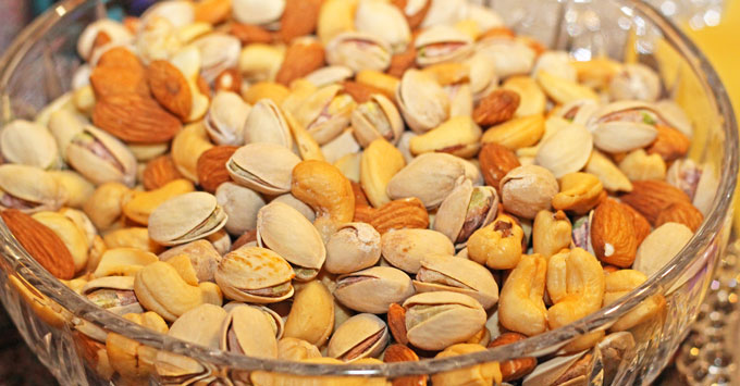 Glass bowl full of mixed nuts.