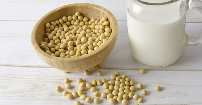 Bowl of soybeans with a glass of milk.