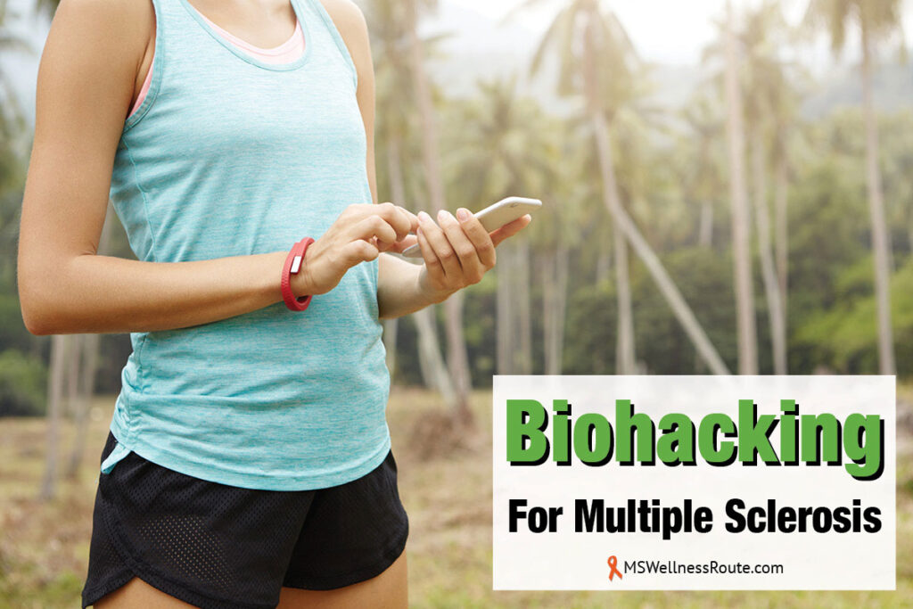 Woman in tank top and shorts holding a smart phone with overlay: Biohacking For Multiple Sclerosis