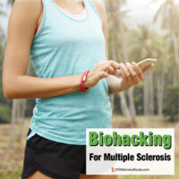 Woman in tank top and shorts holding a smart phone with overlay: Biohacking For Multiple Sclerosis
