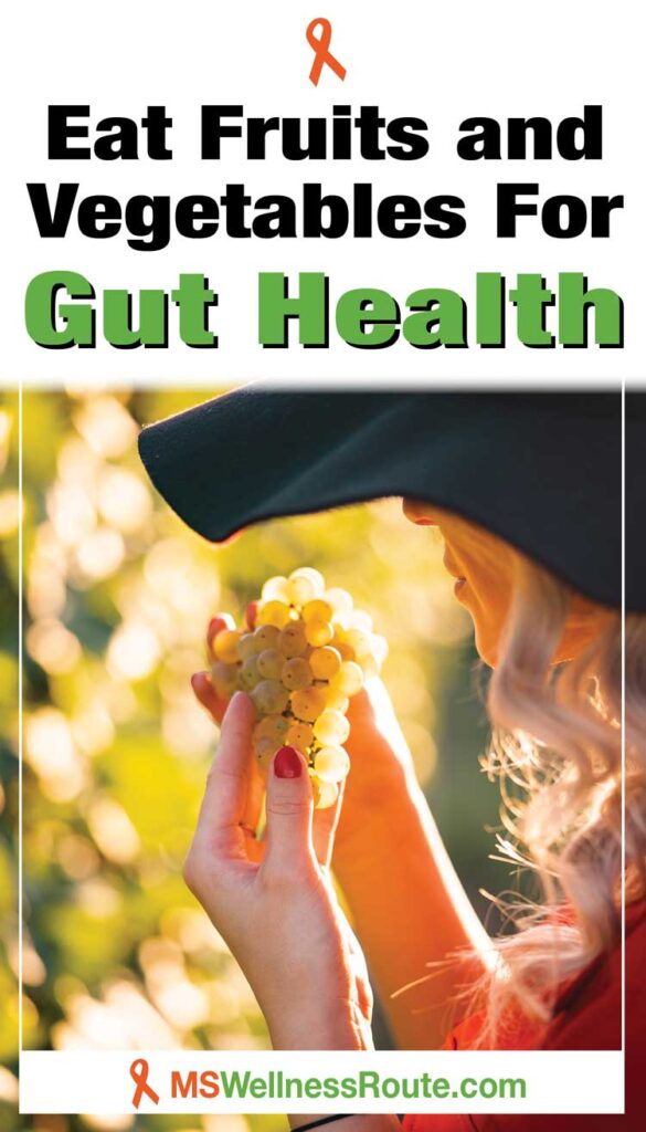 Woman wearing a hat looking at grapes with headline: Eat Fruits and Vegetables for Gut Health