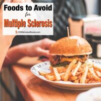 Woman eating a hamburger with overlay: Foods to Avoid with MS