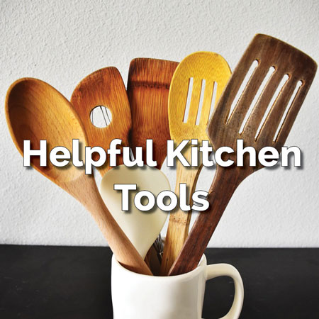 White mug holding wooden spoon with overlay: Helpful Kitchen Tools