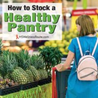 Woman grocery shopping for pineapples with overlay: How to Stock a Healthy Pantry