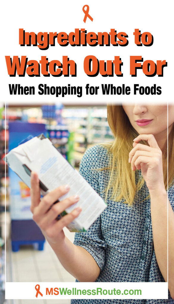 Woman reading label on back of almond milk with headline: Ingredients to Watch Out For When Shopping for Whole Foods