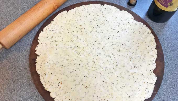 Pizza crust rolled out.