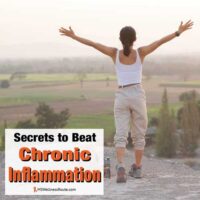 Woman overlooking valley with arms in air with overlay: Secrets to Beat Chronic Inflammation