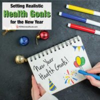 Woman drawing on notebook with colored pens and Christmas decorations with overlay: Setting Realistic Health Goals for the New Year
