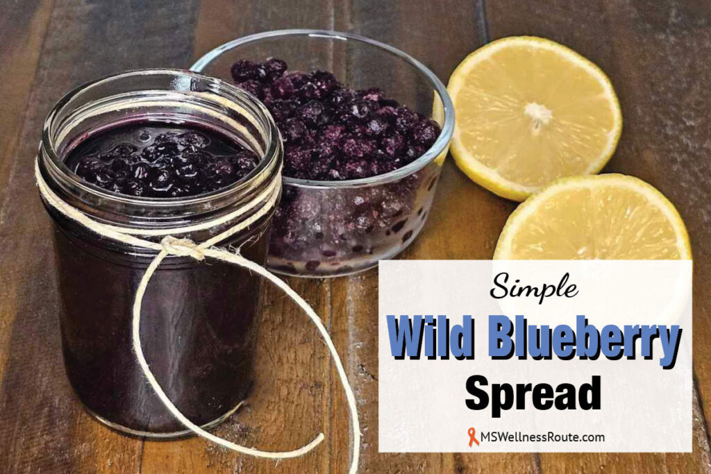 Blue spread in glass jar and lemons with overlay: Simple Wild Blueberry Spread