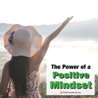 Woman with hat and arm in air with overlay: The Power of a Positive Mindset