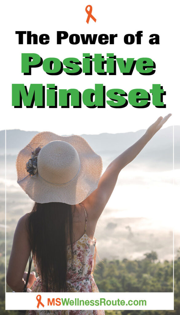 Woman with sunhat and arm in air overlooking lake with overlay: The Power of a Positive Mindset