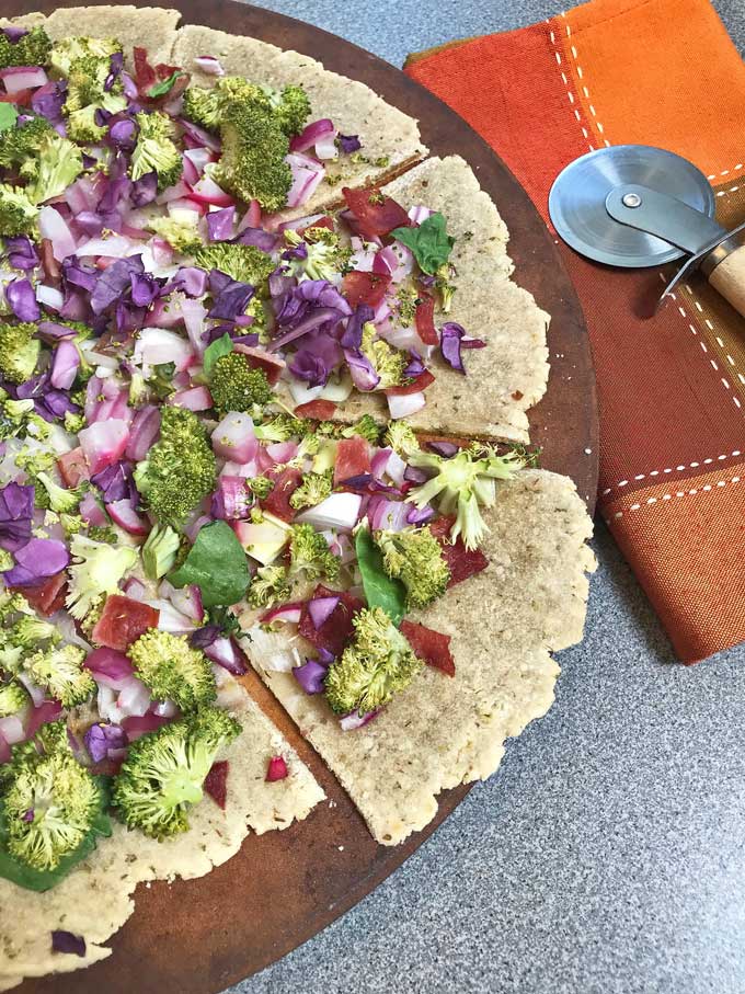 A delicious vegetable and turkey bacon paleo pizza.