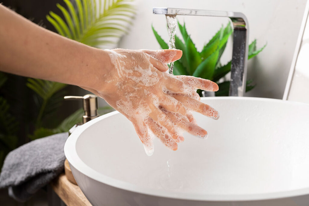 Close up of a woman washing her hands.
