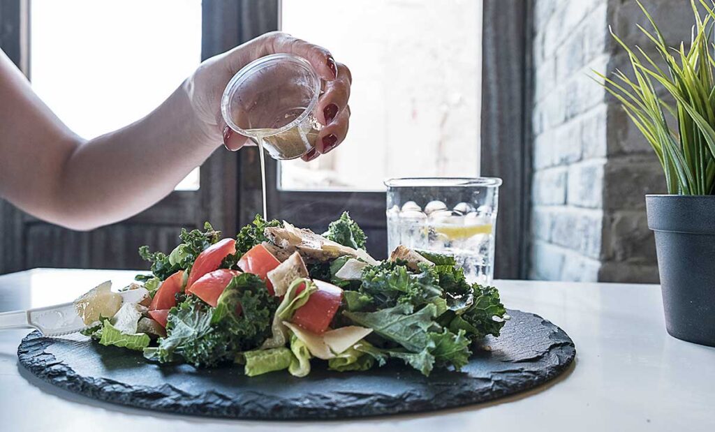 Woman eating a salad on a lazy susan.