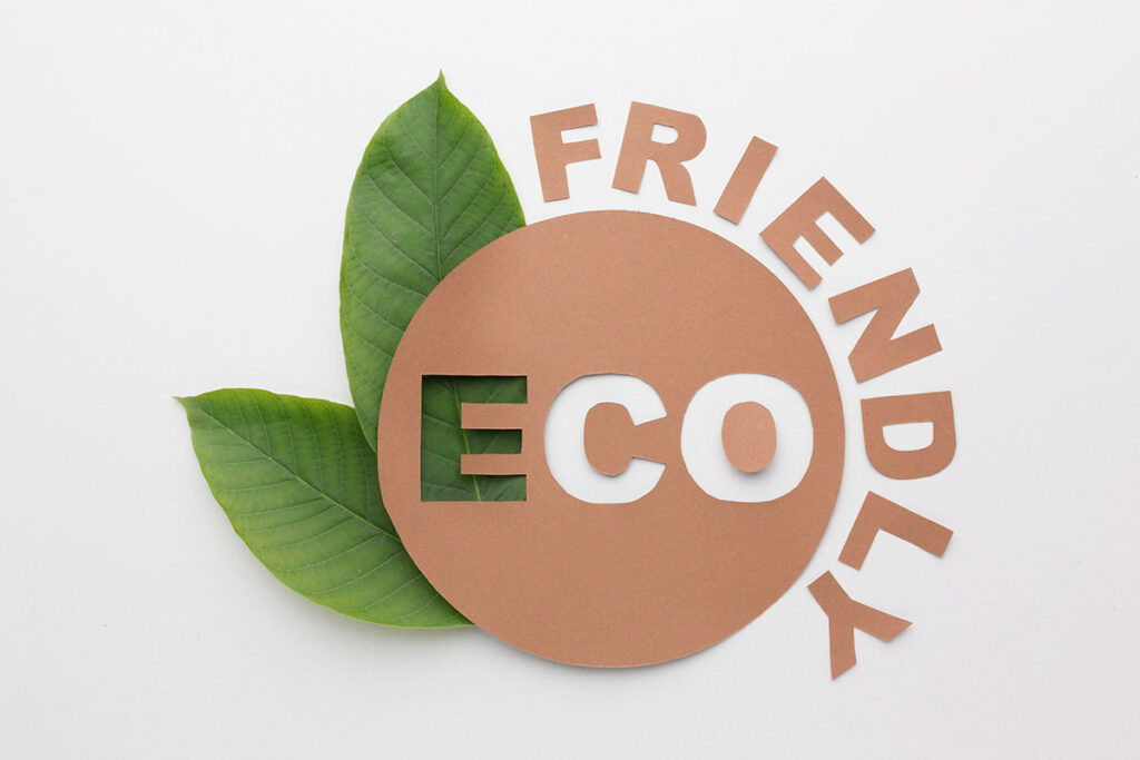 Green leaf with brown paper bag cut out saying Eco Friendly