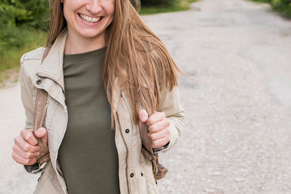 Happy woman walking on path.