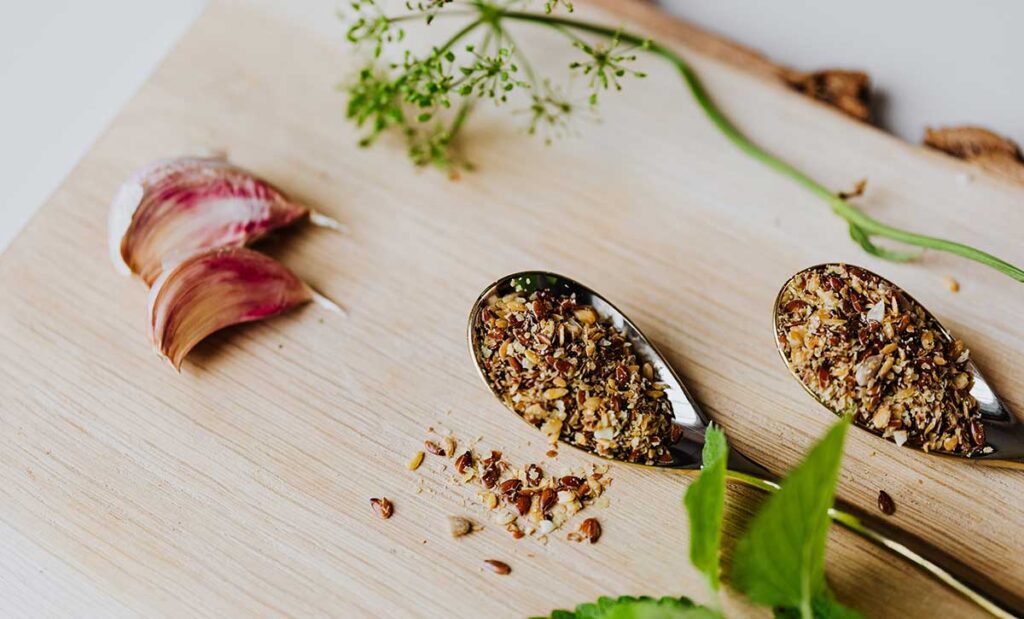 Garlic Cloves, Spices, and Herbs on Stainless Spoons