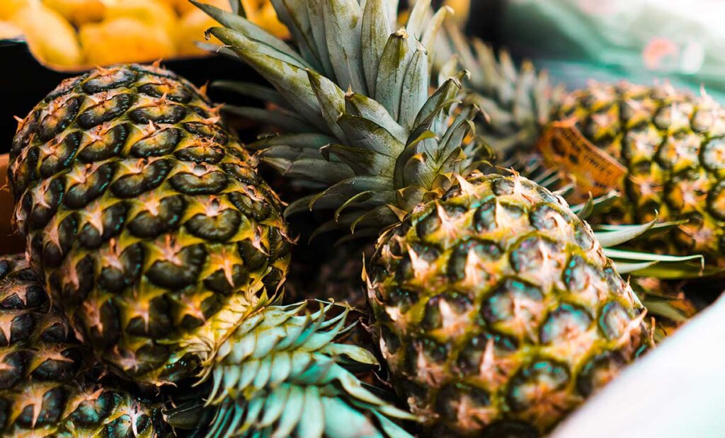 Close up image of three pineapples. 