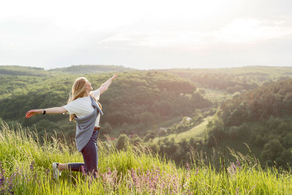 Side view of young blond woman enjoying nature.